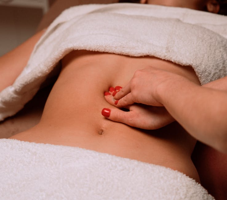 Therapist massaging the stomach of a client at Seoul Korean Massage Omaha