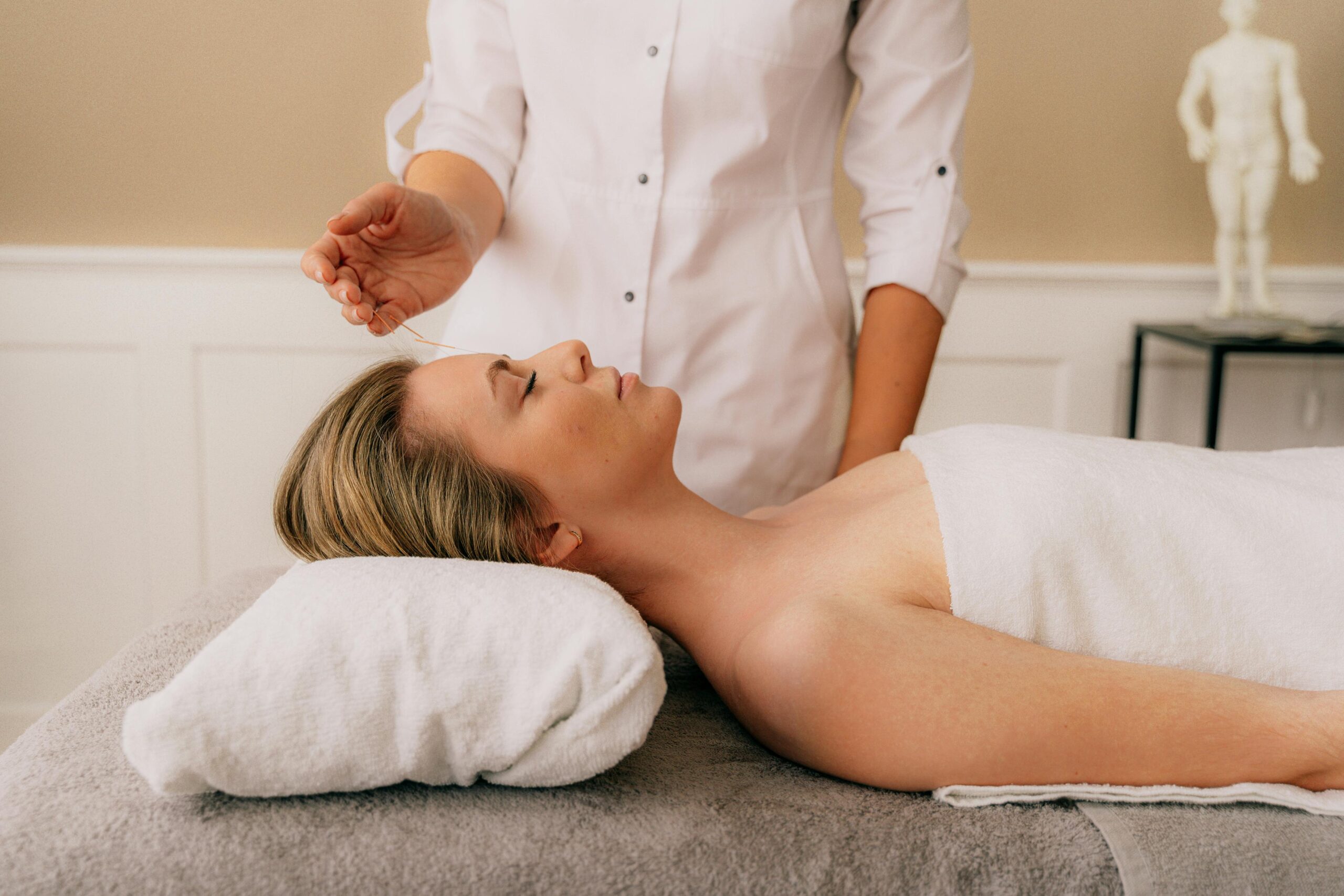 Acupressure massage therapist applying pressure to foot