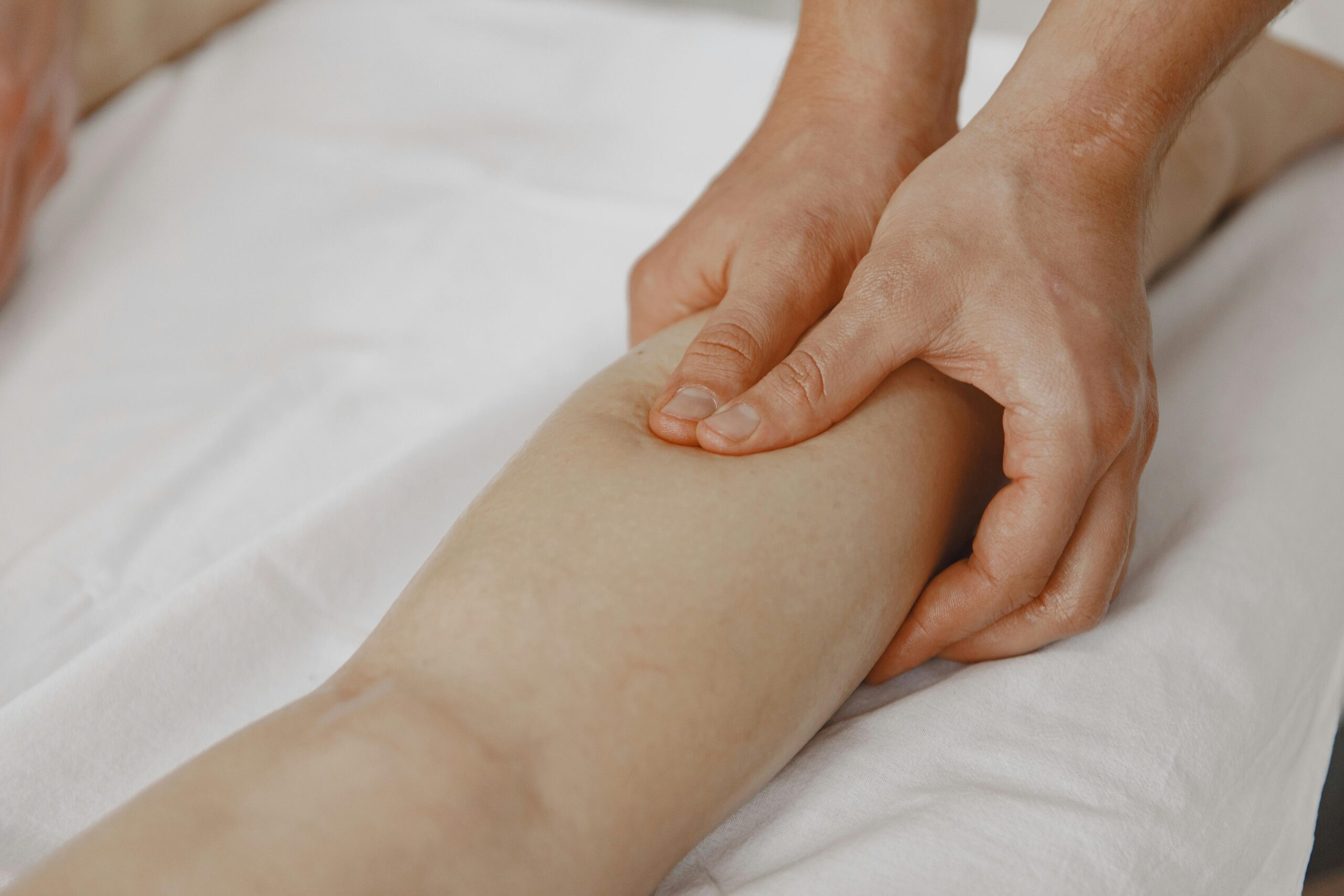 Massage therapist performing deep tissue massage on a client's back