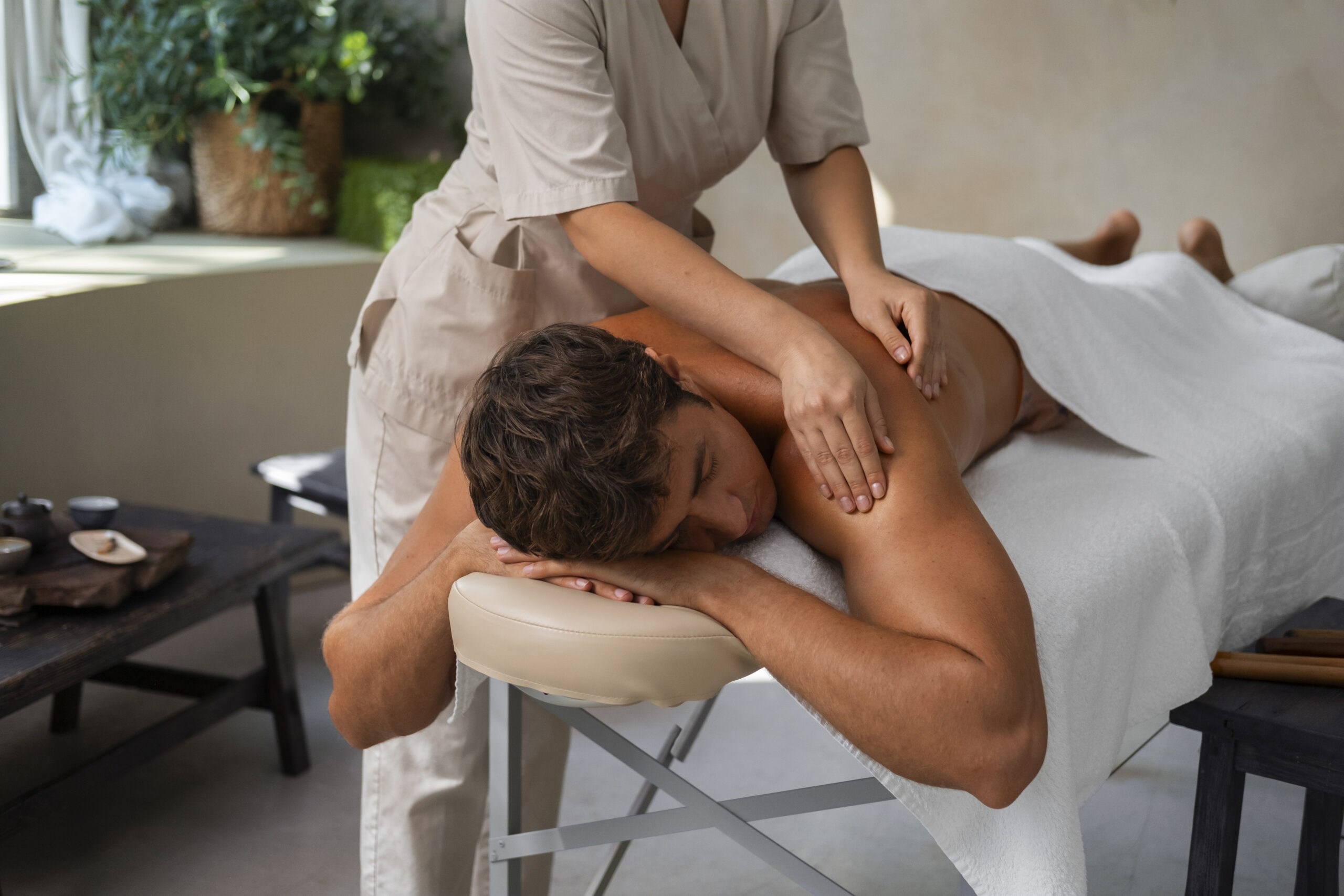 Client receiving a Swedish massage with calming atmosphere