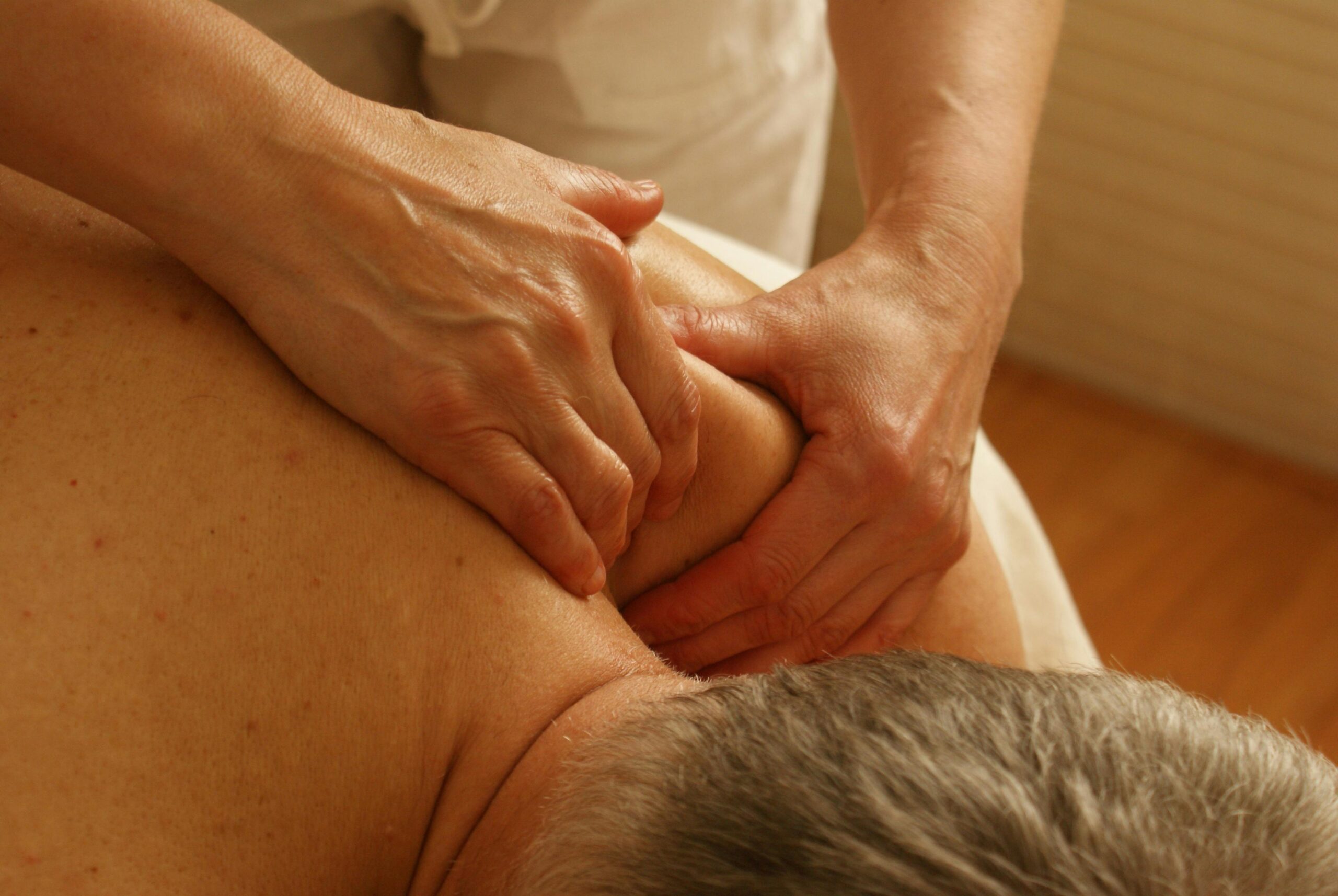 Chinese Tui Na Massage therapist applying pressure to back